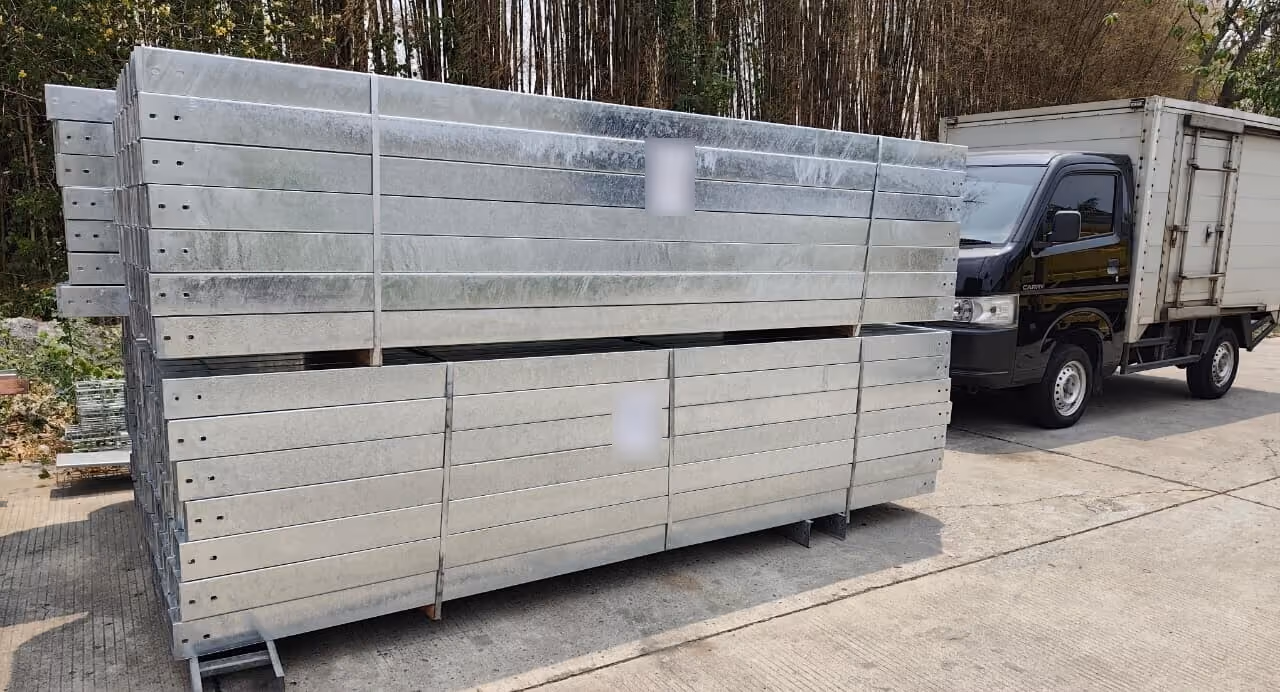 Bundles of hot-dip galvanized cable tray ready for loading next to a box truck