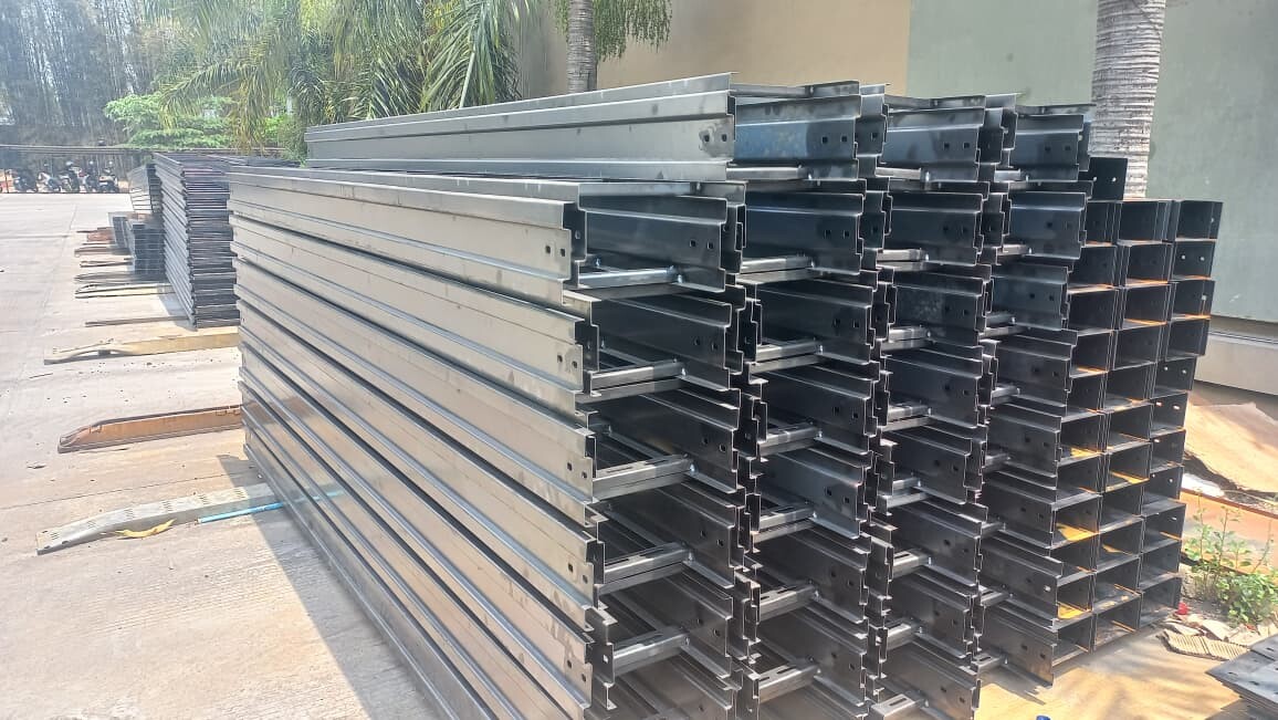Stacked steel cable ladder sections outdoors